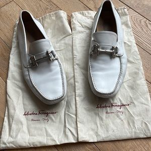 White Salvatore Ferragamo loafers with silver hardware.